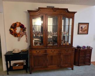 Ethan Allen table, Pennsylvania House china cabinet filled with Hummel figures