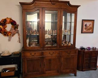 Pennsylvania House china cabinet filled with Hummel figurines