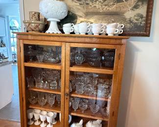 Antique cabinet and full of fostoria and milk glass