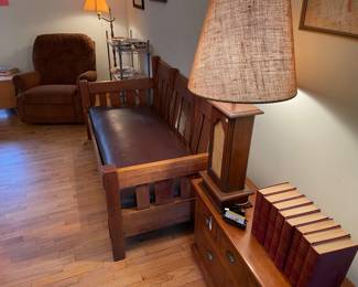Stickley Brothers, 1915 Settle/sofa, from Grand Rapids. Oval making underneath; orange La-Z-Boy recliner; vintage decorative plates; and framed maps. (Lamps, write rack, and small dresser not for sale.)