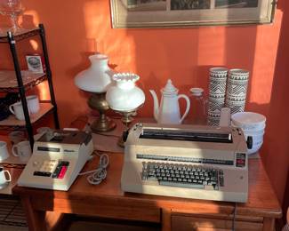 Vintage type writer; vintage adding machine (with cover); oil lamp made into electric lamps; vases; pitchers and bowls; three vintage Netherlands photos in frame; desk (not for sale)