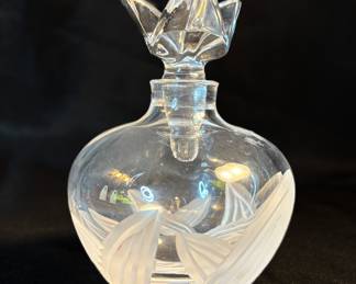  This is a large crystal perfume bottle, specifically the iconic "L'Air du Temps" bottle,  produced by Lalique for the fashion house Nina Ricci.