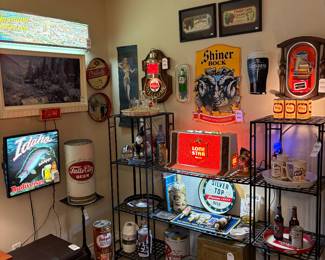 The collection includes lighted and enamel signs...