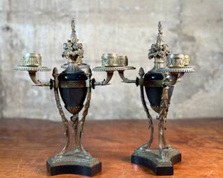 This lot features a pair of antique French gilt bronze and black marble candelabras in very good condition. Each one measures, 12” H x 8” W x 8” D.