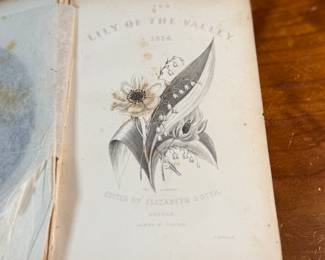 This lot features an antique hardcover book of, "The Lily of the Valley", edited by Elizabeth Doten circa 1854.