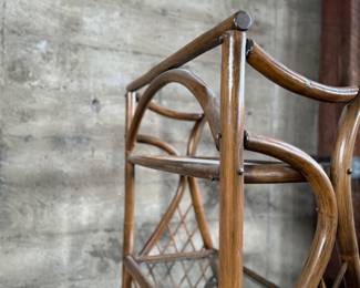 This lot features a vintage rattan shelving unit with two glass shelves on the top two tiers. This unit measures, 71.5” H x 29.5” W x 19.5” D.