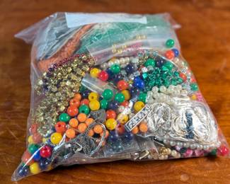 This lot features a large bag of costume jewelry that weighs 3lbs 4oz.