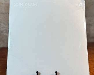 This lot features a sealed vinyl record of the album, Continuum by artist, John Mayer. It is the artist’s third studio album, released in 2006. The album is a 180-gram double vinyl pressing. It includes hit songs like "Waiting on the World to Change" and "Gravity".
