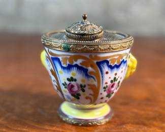 This lot features a collection of inkwells and accessories. One appears to be handmade out of wood and signed underneath by John R Craighead.