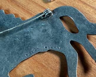 This lot features a collection of Alpaca silver jewelry featuring a horse pin/brooch, a pair of earrings, and a money clip. All items are marked Alpaca as shown in photos and have a total approx. weight of 50.14 grams.