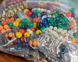 This lot features a large bag of costume jewelry that weighs 3lbs 4oz.