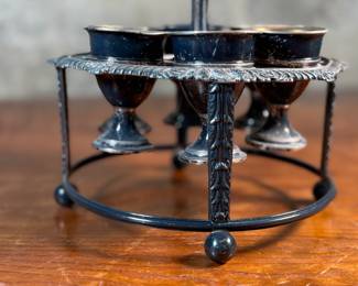 This lot features an antique silver-plated Victorian egg cruet set with six egg cups. This cruet measures, 9” H x 7.5” W x 7.5” D.