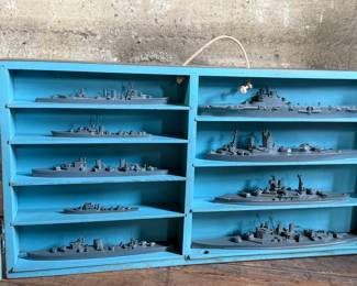 This lot features a complete set of WWII U.S. Navy recognition ship models in their original, self-contained wooden display case. These sets were manufactured by H.A. Framburg & Co. for the U.S. Navy Bureau of Aeronautics to help personnel identify friendly and enemy vessels during the war. This set measures (closed), 18.5” H x 36.5” W x 6.75” D. These models are generally considered 1/1200 scale, and were used as identification and training aids for the Navy during World War II.