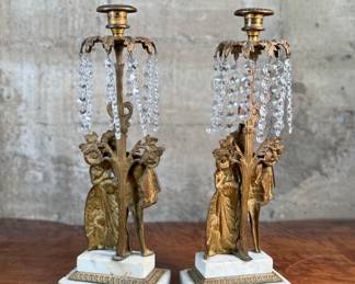 This lot features a pair of high quality Victorian polished brass candelabras with prisms and marble bases. Each one measures, 15.5” H x 5.5” W x 3.5” D.