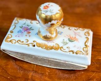This lot features a collection of inkwells and accessories. One appears to be handmade out of wood and signed underneath by John R Craighead.