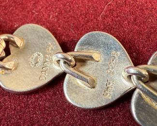 This lot features an iconic sterling silver heart necklace titled, "Chain of Hearts". A Hans Hansen design for Georg Jensen with a total approx. weight of 61.77 grams and measures, 15.5”. Comes in the original box and in excellent condition. The design features a series of meticulously crafted, solid silver heart shapes linked together to create an articulated, choker-style necklace. Maker marks present as shown in photos.