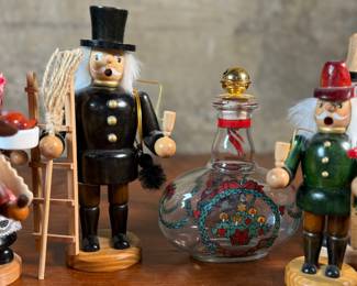 This lot features a large collection of traditional German incense smokers, also known as Räuchermännchen. Also, a decorative glass Christmas bottle and a porcelain bear manufactured by Royal Copenhagen. Maker mark present underneath as shown in photos.
