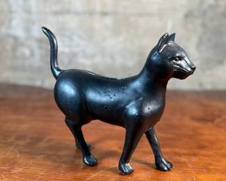This lot features a vintage cast iron “cat” bank that measures, 7.5” H x 9” W x 3” D.