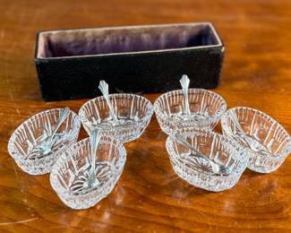 This lot features an antique set of six (6) salt cellars, accompanied by six (6) sterling silver spoons with a total approx. weight of 10.22 grams.