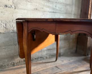 This lot features a 19th century Hepplewhite drop-leaf table in sturdy condition with excellent patina. It measures (closed), 30” H x 28” W x 40” D. When open, it measures, 30” H x 56” W x 40” D.