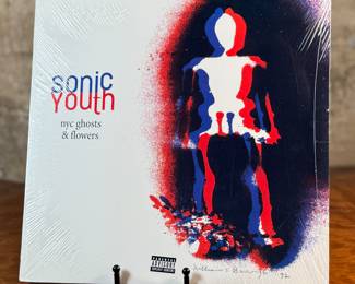 This lot features a sealed vinyl record of the album, NYC Ghosts & Flowers by the band, Sonic Youth. It is the eleventh studio album by the American rock band Sonic Youth, first released on May 16, 2000, by DGC Records. The highly experimental album was a reaction to the theft of the band’s instruments in 1999. The album features tracks such as "Free City Rhymes, " "Renegade Princess, " and the title song "NYC Ghosts & Flowers".