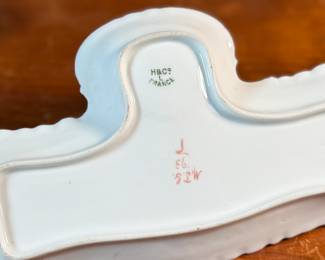 This lot features a collection of inkwells and accessories. One appears to be handmade out of wood and signed underneath by John R Craighead.