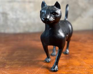 This lot features a vintage cast iron “cat” bank that measures, 7.5” H x 9” W x 3” D.