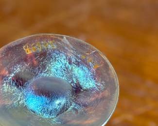 This lot features an iridescent gold Tiffany Favrile sherbet glass with maker marks present underneath as shown in photos. One small repair on the foot ring and measures, 3.5” H x 4” W x 4” D.