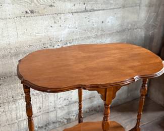 This lot features a solid wood oval shaped parlor table that measures, 29” H x 30” W x 20” D.