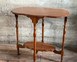 This lot features a solid wood oval shaped parlor table that measures, 29” H x 30” W x 20” D.