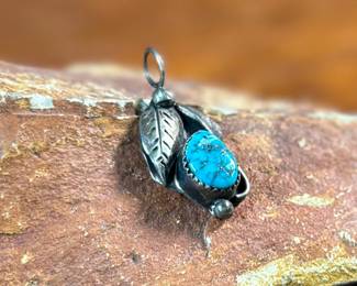 This lot features a sterling silver pendant with a turquoise stone, signed by listed artist, David F. Garcia. This pendant measures, 1.25” H and has a total approx. weight of 3.50 grams.