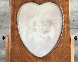 “Cupid Awake”, a rather famous portrait taken by master photographer, M.B. Parkinson held in an incredible quarter-sawn oak frame. This photo measures in frame, 24” H x 20” W. Morris Burke Parkinson was an American photographer, best known for his “Cupid Awake” and “Cupid Asleep” photos, which were supplied in frames produced by the Ohio Art Company circa 1912. Parkinson was born around Buffalo, New York, but moved with his family to Oshkosh, Wisconsin soon after.