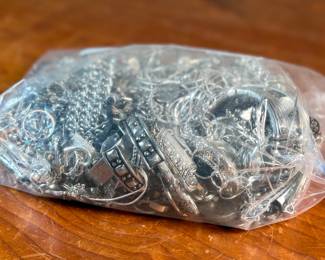 This lot features a large bag of costume jewelry that weighs 4lbs.