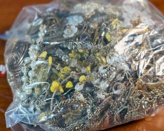 This lot features a large bag of costume jewelry that weighs 4lbs.