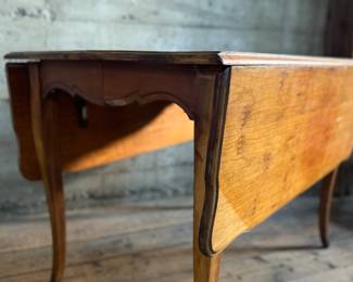 This lot features a 19th century Hepplewhite drop-leaf table in sturdy condition with excellent patina. It measures (closed), 30” H x 28” W x 40” D. When open, it measures, 30” H x 56” W x 40” D.