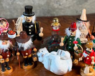 This lot features a large collection of traditional German incense smokers, also known as Räuchermännchen. Also, a decorative glass Christmas bottle and a porcelain bear manufactured by Royal Copenhagen. Maker mark present underneath as shown in photos.