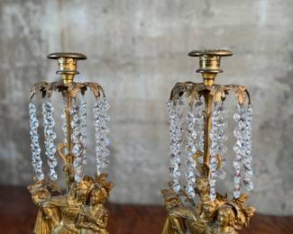 This lot features a pair of high quality Victorian polished brass candelabras with prisms and marble bases. Each one measures, 15.5” H x 5.5” W x 3.5” D.