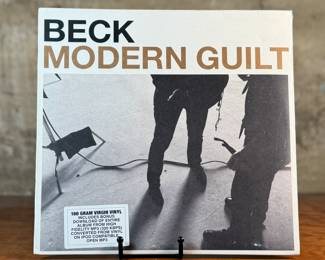 This lot features a sealed vinyl record for the album Modern Guilt by American musician, Beck. This record was co-produced by Beck and Danger Mouse. This is also the 180-gram virgin vinyl edition that includes a bonus download of the entire album in MP3 format.