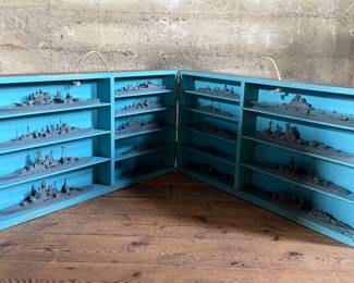 This lot features a complete set of WWII U.S. Navy recognition ship models in their original, self-contained wooden display case. These sets were manufactured by H.A. Framburg & Co. for the U.S. Navy Bureau of Aeronautics to help personnel identify friendly and enemy vessels during the war. This set measures (closed), 18.5” H x 36.5” W x 6.75” D. These models are generally considered 1/1200 scale, and were used as identification and training aids for the Navy during World War II.