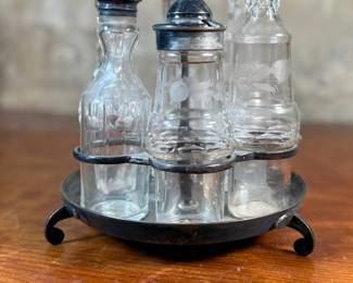 This lot features a Victorian cruet set, manufactured by Wildman’s. Maker marks present underneath as shown in photos. This cruet set measures, 10” H x 7” W x 7” D.