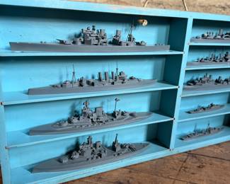 This lot features a complete set of WWII U.S. Navy recognition ship models in their original, self-contained wooden display case. These sets were manufactured by H.A. Framburg & Co. for the U.S. Navy Bureau of Aeronautics to help personnel identify friendly and enemy vessels during the war. This set measures (closed), 18.5” H x 36.5” W x 6.75” D. These models are generally considered 1/1200 scale, and were used as identification and training aids for the Navy during World War II.