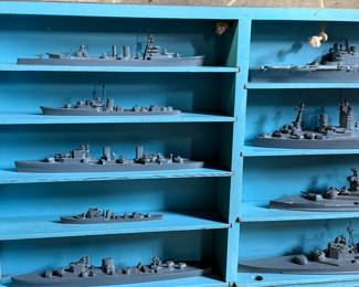 This lot features a complete set of WWII U.S. Navy recognition ship models in their original, self-contained wooden display case. These sets were manufactured by H.A. Framburg & Co. for the U.S. Navy Bureau of Aeronautics to help personnel identify friendly and enemy vessels during the war. This set measures (closed), 18.5” H x 36.5” W x 6.75” D. These models are generally considered 1/1200 scale, and were used as identification and training aids for the Navy during World War II.