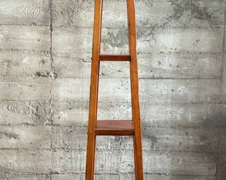 This lot features a modern three-tier shelving unit that measures, 60” H x 15” W x 15” D.