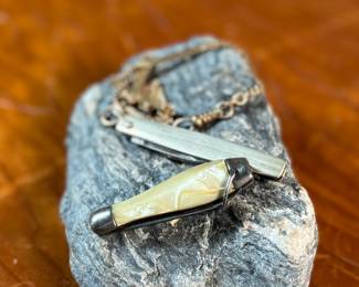 This lot features a pair of vintage pocket knives along with one being attached to a pocket knife chain, manufactured by H & H. Maker marks present as shown in photos.