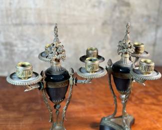 This lot features a pair of antique French gilt bronze and black marble candelabras in very good condition. Each one measures, 12” H x 8” W x 8” D.
