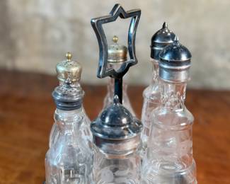 This lot features a Victorian cruet set, manufactured by Wildman’s. Maker marks present underneath as shown in photos. This cruet set measures, 10” H x 7” W x 7” D.
