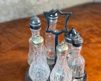 This lot features a Victorian cruet set, manufactured by Wildman’s. Maker marks present underneath as shown in photos. This cruet set measures, 10” H x 7” W x 7” D.