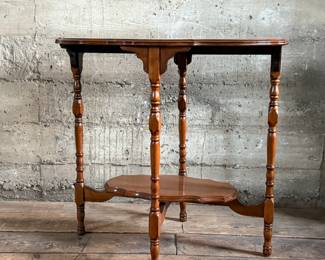 This lot features a solid wood oval shaped parlor table that measures, 29” H x 30” W x 20” D.