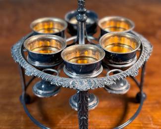 This lot features an antique silver-plated Victorian egg cruet set with six egg cups. This cruet measures, 9” H x 7.5” W x 7.5” D.