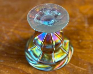 This lot features an iridescent gold Tiffany Favrile sherbet glass with maker marks present underneath as shown in photos. One small repair on the foot ring and measures, 3.5” H x 4” W x 4” D.